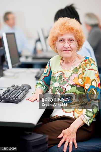 smiling senior woman in a computer lab - old computer lab stock pictures, royalty-free photos & images