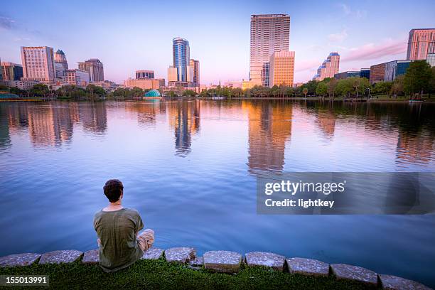 man enjoying the view in orlando - orlando florida buildings stock pictures, royalty-free photos & images