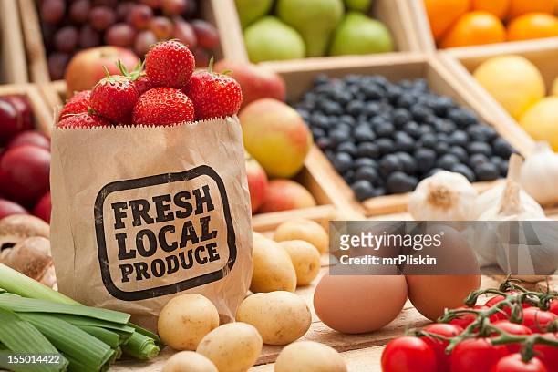 fruit and vegetables on a counter top - farm produce market stock pictures, royalty-free photos & images