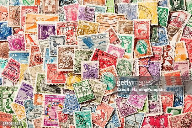 background of old, canceled postage stamps. xxxl - postage stamp stock pictures, royalty-free photos & images