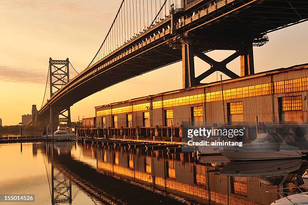 ben franklin bridge and marina at sunrise - delaware river stock pictures, royalty-free photos & images