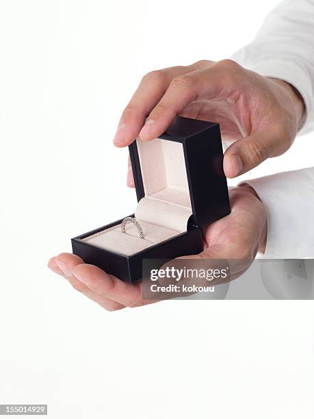 marry me - man holding ring box stock pictures, royalty-free photos & images