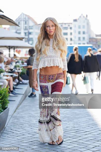 German actress Jenny Elvers, wearing along skirt by Etro and a short white blouse with ruffles, seen at the Marcel Ostertag Show during the Berlin...