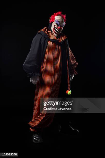 creepy adult clown halloween costume portrait on black - scary clown 個照片及圖片檔