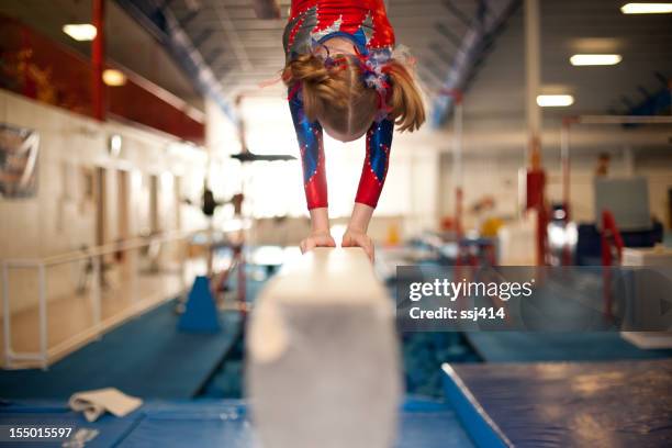 young gymnast doing handstand on balance beam - floor gymnastics bildbanksfoton och bilder