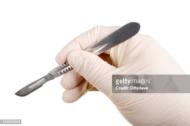 hand in glove holding scalpel - scalpel stock pictures, royalty-free photos & images
