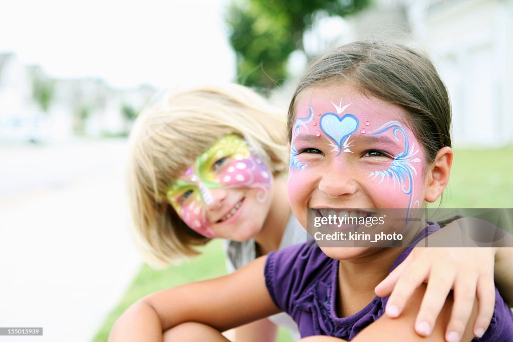 Happy young girls with painted faces
