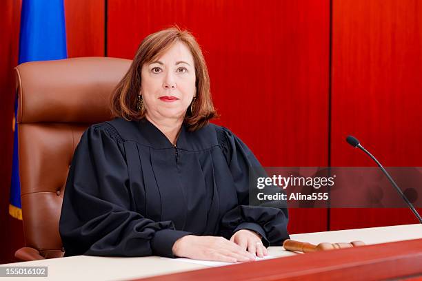 senior female judge at the bench in a courtroom - woman judge stock pictures, royalty-free photos & images