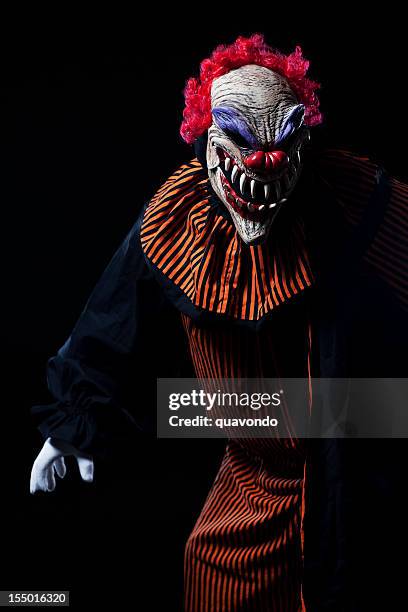 creepy adult clown halloween costume portrait on black - scary clown 個照片及圖片檔