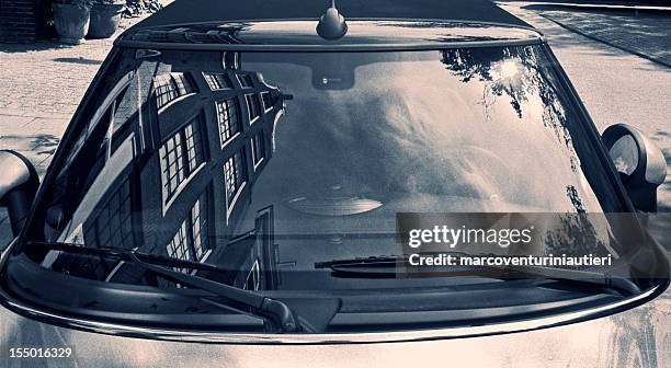 typically dutch architecture reflected in a car windscreen - voorruit stockfoto's en -beelden