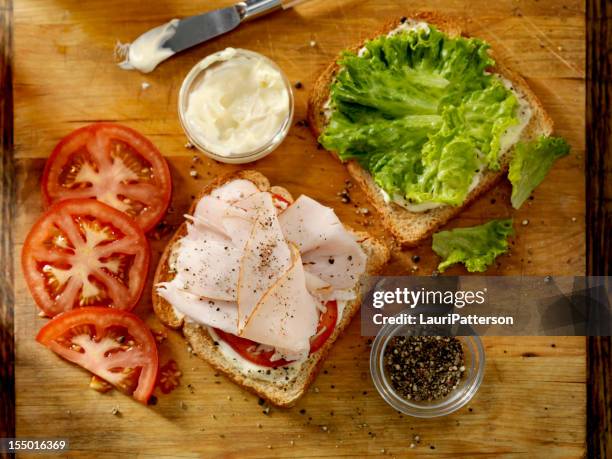 preparing a turkey sandwich - making a sandwich stockfoto's en -beelden