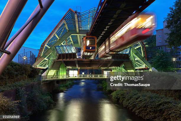 wuppertal suspension railway in germany lit up at night - wuppertal stock pictures, royalty-free photos & images