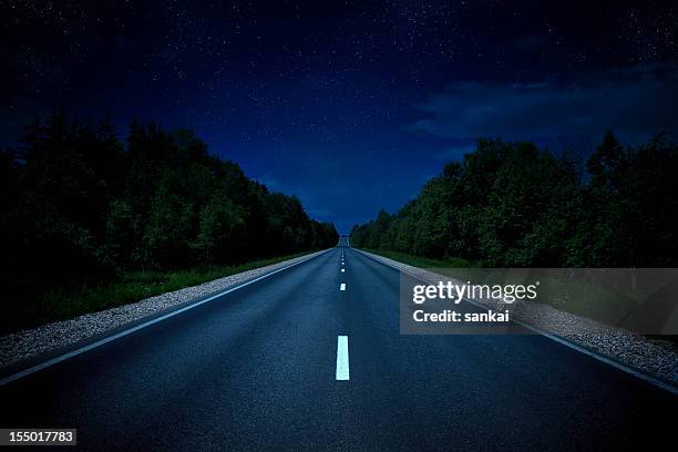 country highway in the night - road night stock pictures, royalty-free photos & images