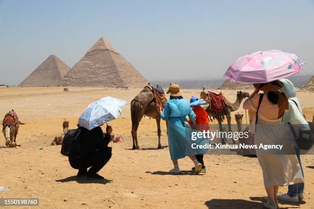 Tourists visit the Giza Pyramids scenic spot during a heatwave, in Giza, Egypt, July 22, 2023.