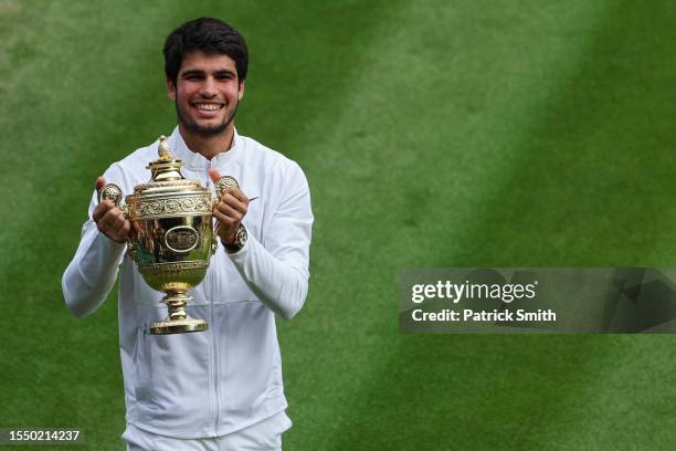 Carlos Alcaraz of Spain celebrates with the Men's Singles Trophy following his victory in the Men's Singles Final against Novak Djokovic of Serbia on...