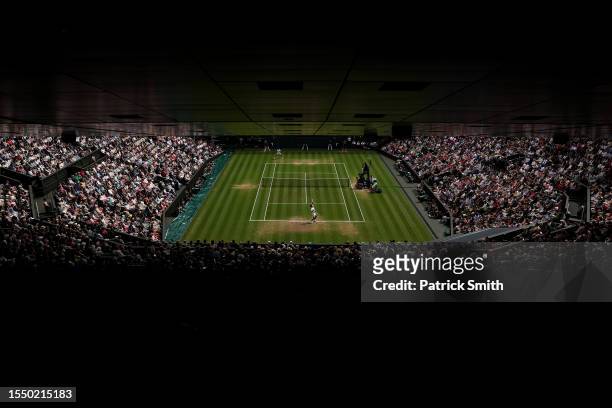 General view as Carlos Alcaraz of Spain serves in the Men's Singles Final against Novak Djokovic of Serbia on day fourteen of The Championships...