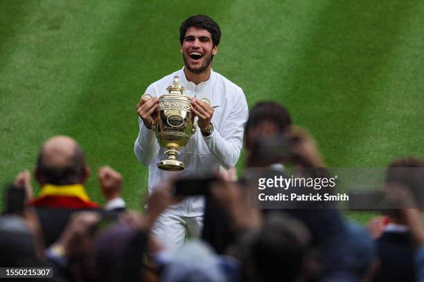 Carlos Alcaraz of Spain celebrates with the Men's Singles Trophy following his victory in the Men's Singles Final against Novak Djokovic of Serbia on...