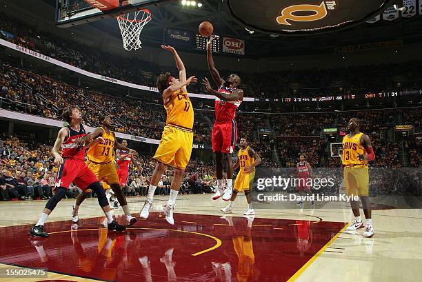 Emeka Okafor of the Washington Wizards tosses up the shot against Anderson Varejao of the Cleveland Cavaliers at The Quicken Loans Arena on October...