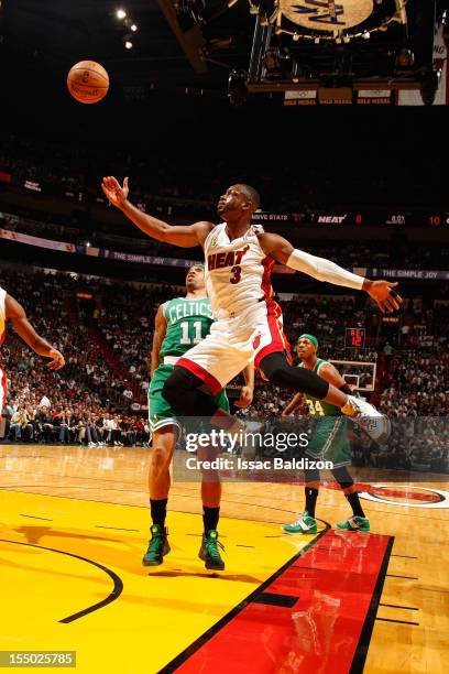 Dwyane Wade of the Miami Heat reaches for a rebound against Courtney Lee of the Boston Celtics during the NBA game on October 30, 2012 at American...