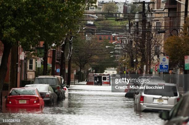 An ambulance sits abandoned in the middle of a flooded street after Hurricane Sandy October 30, 2012 in Hoboken, New Jersey. The storm has claimed at...