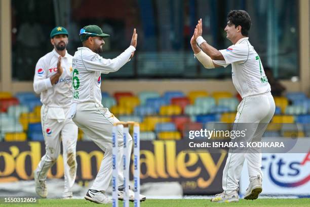 Pakistan's Naseem Shah celebrates with captain Babar Azam after taking the wicket of Sri Lanka's Angelo Mathews during the first day of the second...