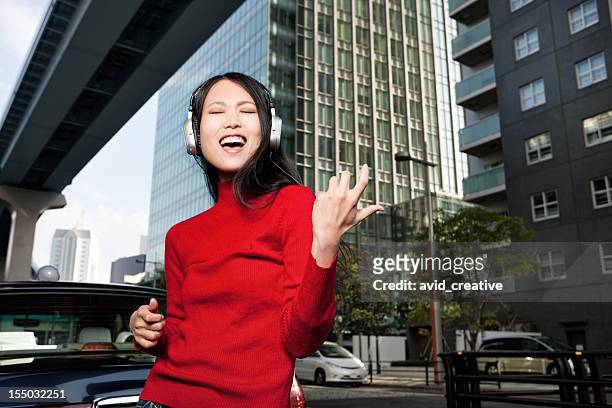 asian female plays air guitar - air guitar stock pictures, royalty-free photos & images