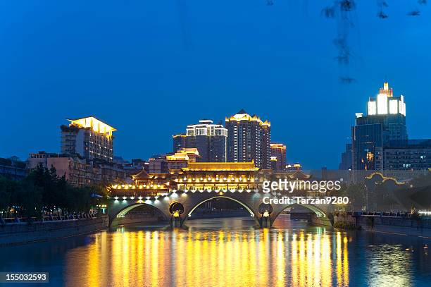 chinese style bridge in front of skyscrapers - urban tarzan stock pictures, royalty-free photos & images