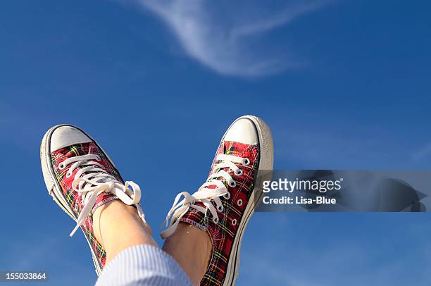 feet up w sport shoes against blue sky.copy space - feet up stock pictures, royalty-free photos & images