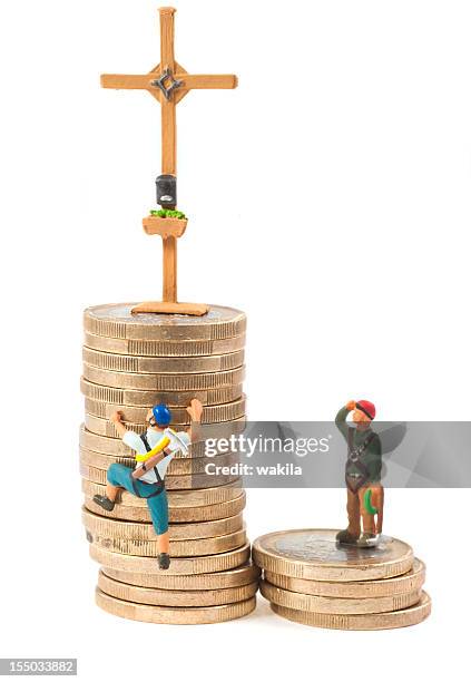 climb on tower of money - gipfelkreuz - figurine stock pictures, royalty-free photos & images