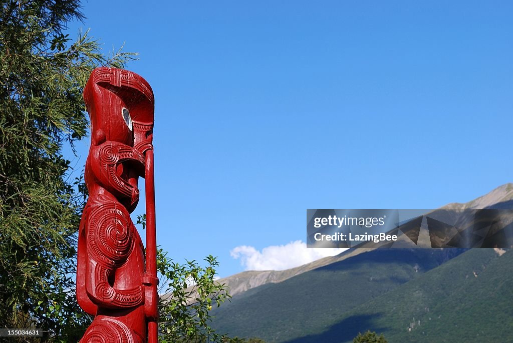 Maori Totem (Pou) looking out to distant Mountains