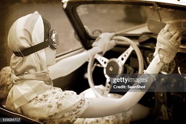 tinted picture of woman in goggles driving a vintage car. - 20th century model car stock pictures, royalty-free photos & images