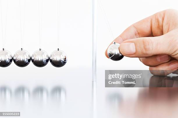 newton's cradle - swinging balls stock pictures, royalty-free photos & images