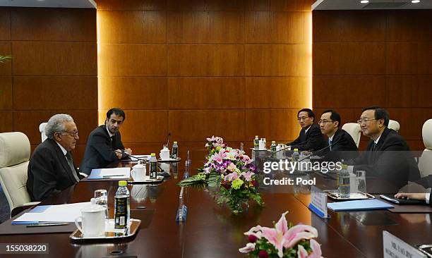 Arab League peace envoy for Syria Lakhdar Brahimi talks with Chinese Foreign Minister Yang Jiechi during their meeting at the Ministry of Foreign...