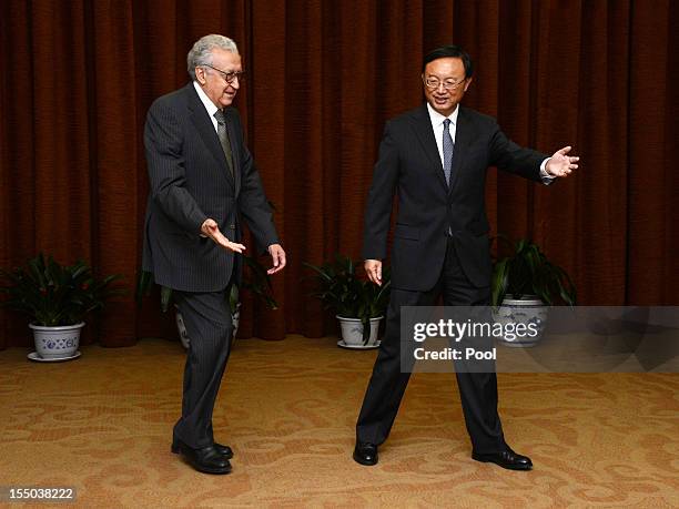 Arab League peace envoy for Syria Lakhdar Brahimi walks with Chinese Foreign Minister Yang Jiechi prior to their meeting at the Ministry of Foreign...