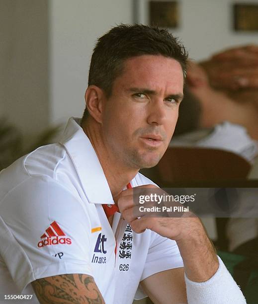 Kevin Pietersen of England looks on outside the dressing room as he waits to bat during the second day of the first tour match between India A and...