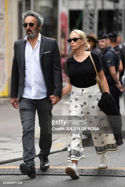 French actress Emmanuelle Beart and her husband documentary filmmaker Frederic Chaudier arrive to attend the funeral ceremony for late British-French...