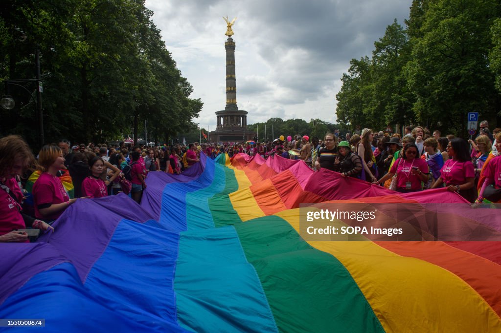 Pride Walk People march with huge pride flag during the pride parade. Berlin ...