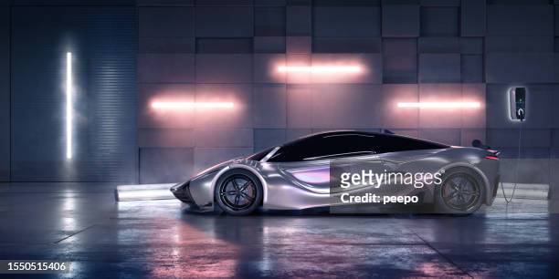 electric sports car charging in warehouse - close to stockfoto's en -beelden