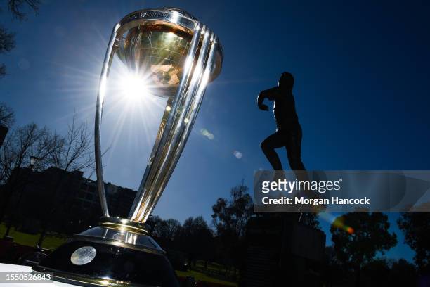 The ICC Men's Cricket World Cup trophy can be seen in front of the Shane Warne statue during an ICC World Cup Media Opportunity at Melbourne Cricket...
