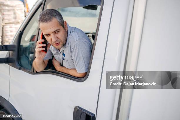 man working in delivery service using delivery van and talking on phone - tradesman van stock pictures, royalty-free photos & images