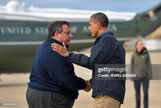 President Barack Obama is greeted by New Jersey Governor Chris Christie upon arriving in Atlantic City, New Jersey, on October 31, 2012 to visit...