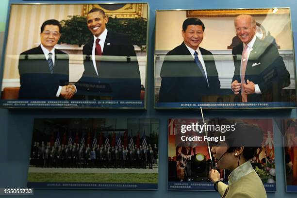 Guide introduces the photo of China's President Hu Jintao and Vice President Xi Jinping as Chinese people visiting an exhibition entitled "Scientific...