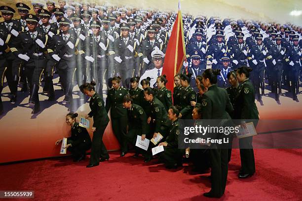 Female soldiers pose for photos as visiting an exhibition entitled "Scientific Development and Splendid Achievements" before the18th National...