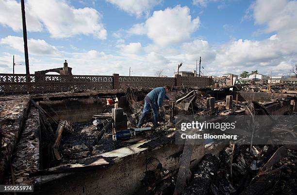 Resident looks through the remnants of his home in the Breezy Point neighborhood of the Queens borough of New York, U.S., on Wednesday, Oct. 31,...