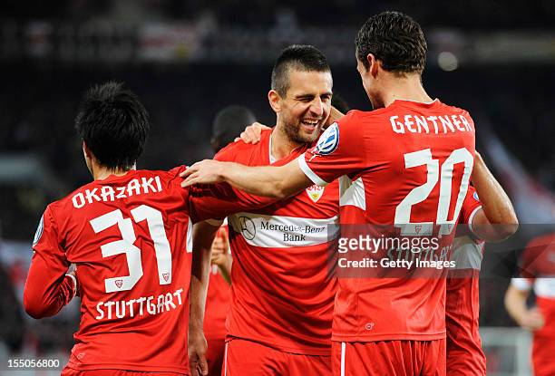 Vedad Ibisevic of Stuttgart celebrates his team's second goal with team members Shinji Okazaki and Christian Gentner during the second round match of...