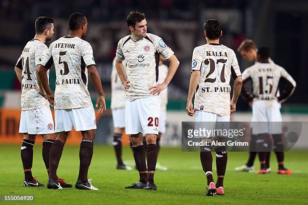 Players of St. Pauli react during the second round match of the DFB Cup between VfB Stuttgart and FC St.Pauli at Mercedes-Benz Arena on October 31,...