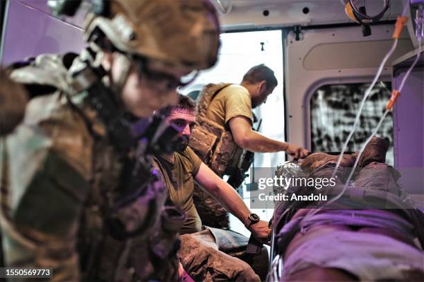 Wounded soldiers are taken care of by 3rd Assault Brigade medics near Bakhmut frontline during a counter-offensive in Donbas, Ukraine on July 23,...