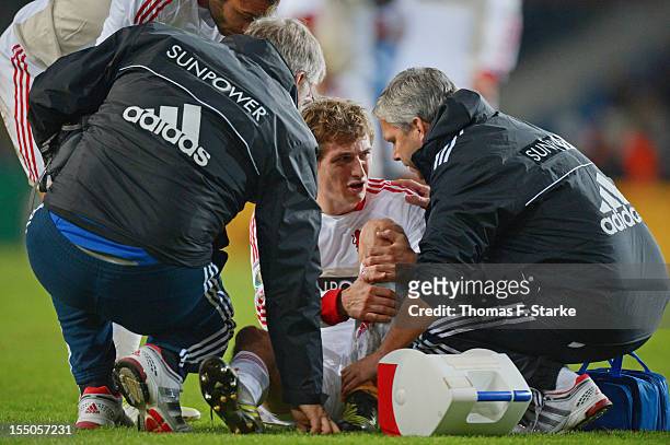 Daniel Schwaab receives medical threatment during the DFB Cup match between Arminia Bielefeld and Bayer 04 Leverkusen at Schueco Arena on October 31,...