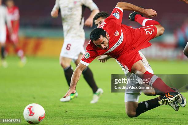 Cristian Molinaro of Stuttgart is challenged by Jan-Philipp Kalla of St. Pauli during the second round match of the DFB Cup between VfB Stuttgart and...