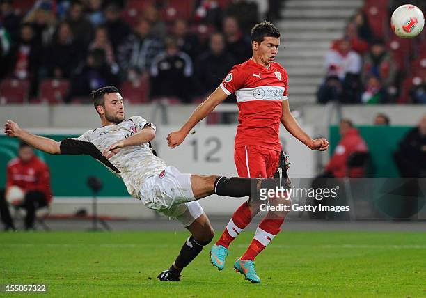 Kevin Stoeger of Stuttgart is challenged by Florian Mohr of St. Pauli during the second round match of the DFB Cup between VfB Stuttgart and FC St....